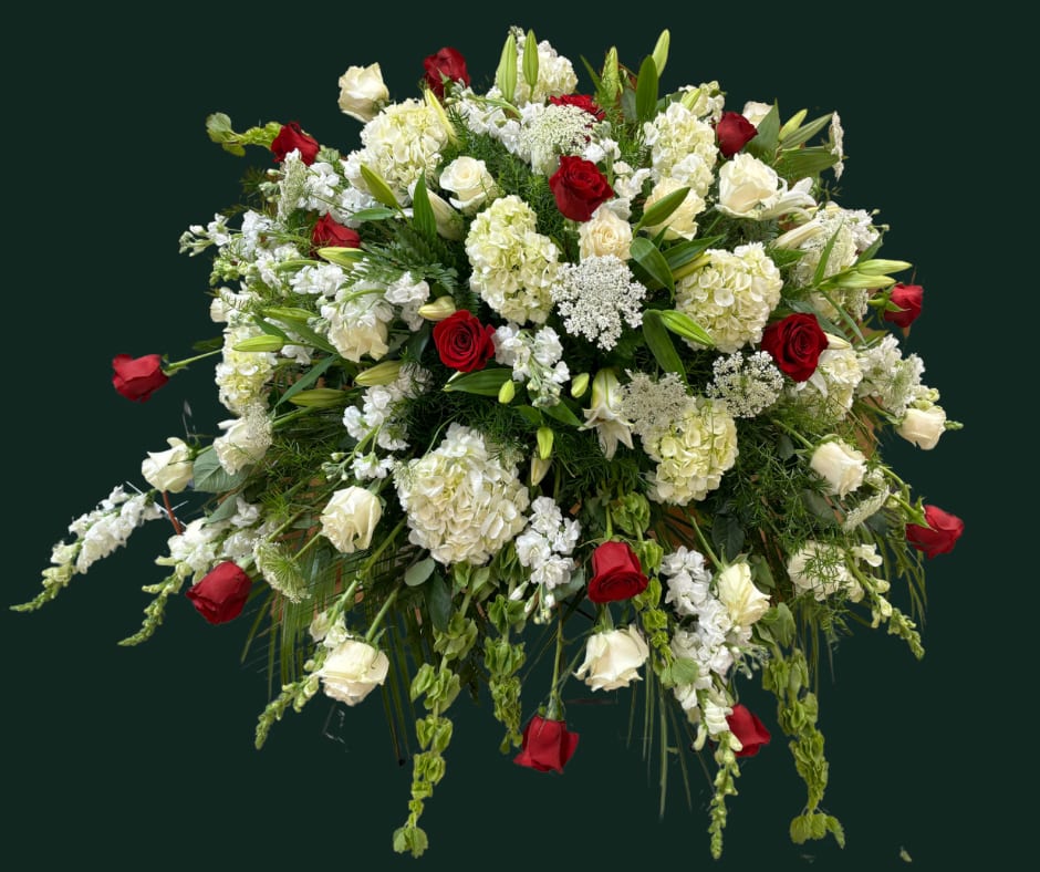 Large floral spray of red and white roses with white lilies and hydrangeas