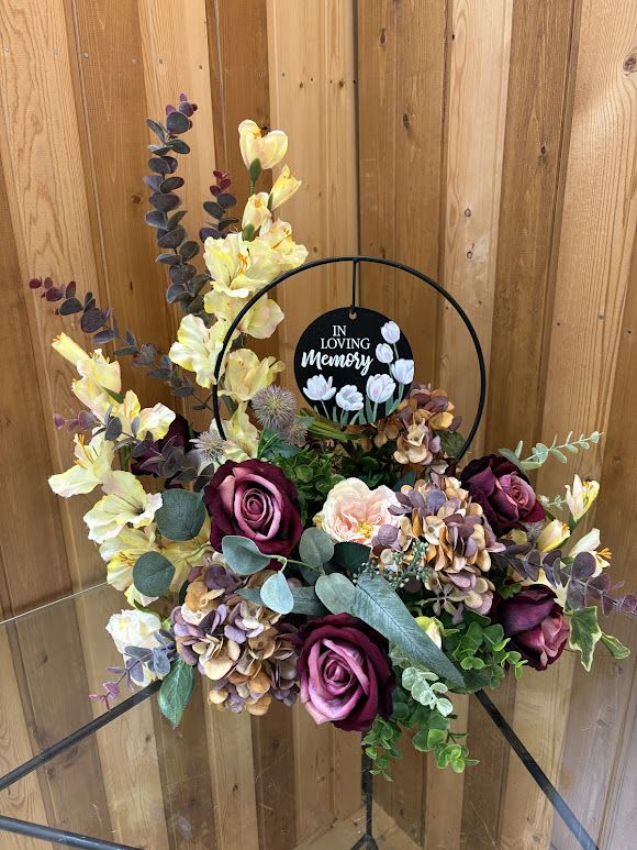 Floral sympathy wreath with roses and hydrangeas on a stand