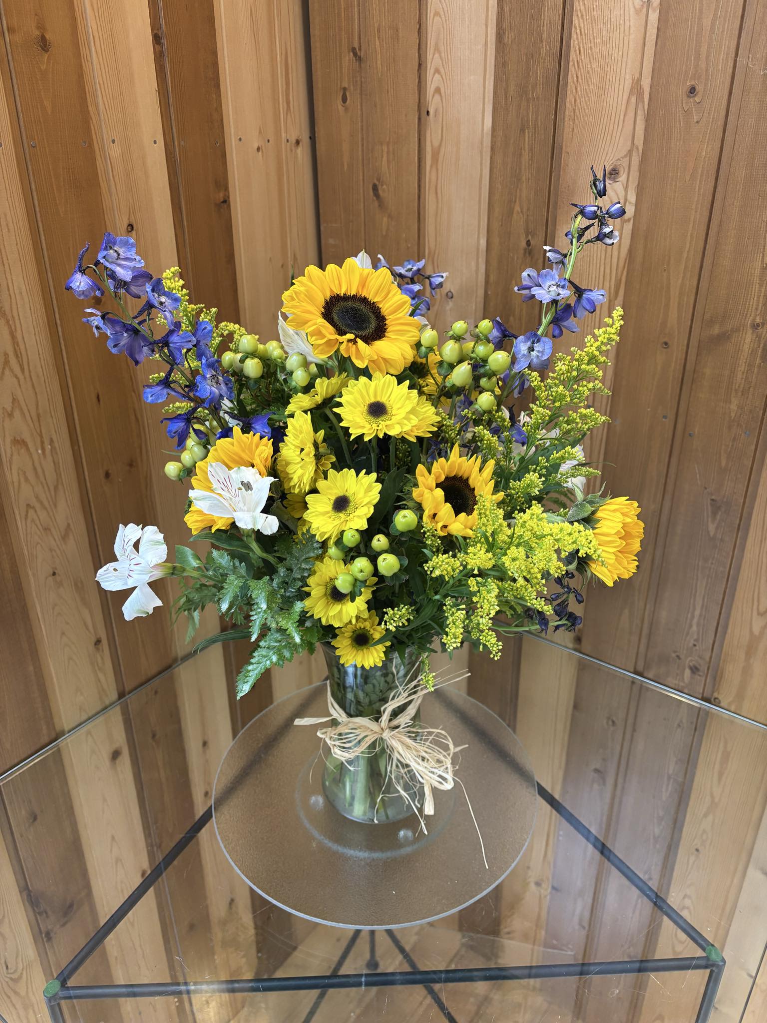 The Flowers of Fall -  Fall Fresh Flower Vase Arrangement with Sunflowers – Brighten Your Home with Autumn Beauty  Celebrate the warmth and color of the season with our Fall Fresh Flower Vase Arrangement, featuring cheerful sunflowers and the rich hues of autumn. Handcrafted by the floral designers at Haehn Florist &amp; Greenhouses in Wapakoneta, Ohio, this stunning bouquet captures everything you love about fall — golden tones, cozy charm, and natural beauty.  Each arrangement is designed in a stylish vase filled with fresh seasonal blooms such as:  Vibrant sunflowers – the heart of the design  Rust and orange mums for texture  Red and gold accent flowers for depth and warmth  Seasonal greens for a lush, full look  Perfect for your dining table, office, or as a thoughtful gift for birthdays, thank-yous, or fall celebrations, this vase arrangement brings the joy of autumn indoors.  Available in multiple sizes and customizable with your favorite fall flowers.  Available now at Haehn Florist &amp; Greenhouses  410 Hamilton Rd., Wapakoneta, OH  419-738-8485   Fresh. Bright. Beautiful — the perfect touch of fall for any space.