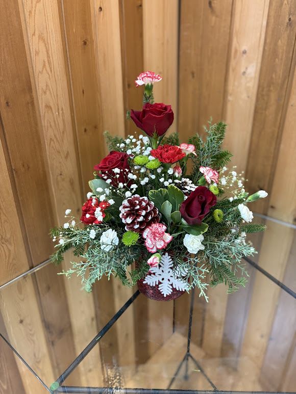 Red roses and carnations in a festive holiday arrangement
