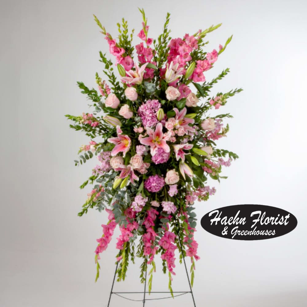 Tall pink floral standing spray on a metal easel