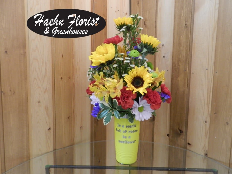 Be a Sunflower Cup Arrangement - Summery Sunflower Stainless Steel Tumbler Bouquet   Brighten someone’s day with this cheerful, summery bouquet designed and hand-arranged by Haehn Florist &amp; Greenhouses in Wapakoneta, Ohio. This one-of-a-kind gift comes in a reusable engraved stainless steel tumbler that reads:   “In a world full of roses, be a sunflower.”  Perfect for birthdays, thank-yous, encouragement, or simply to spread sunshine, this arrangement combines vibrant seasonal blooms with a keepsake tumbler that can be enjoyed long after the flowers are gone.   Yellow Cup Note: If the yellow engraved tumbler is temporarily sold out, a bright orange version will be substituted unless you request a different available color when placing your order.  Whether you’re sending love locally or treating yourself, this bouquet-and-tumbler duo is sure to leave a lasting impression.   Haehn Florist &amp; Greenhouses 410 Hamilton Rd, Wapakoneta, OH 45895  419-738-8485  Order today and let us help you deliver a little sunshine! 
