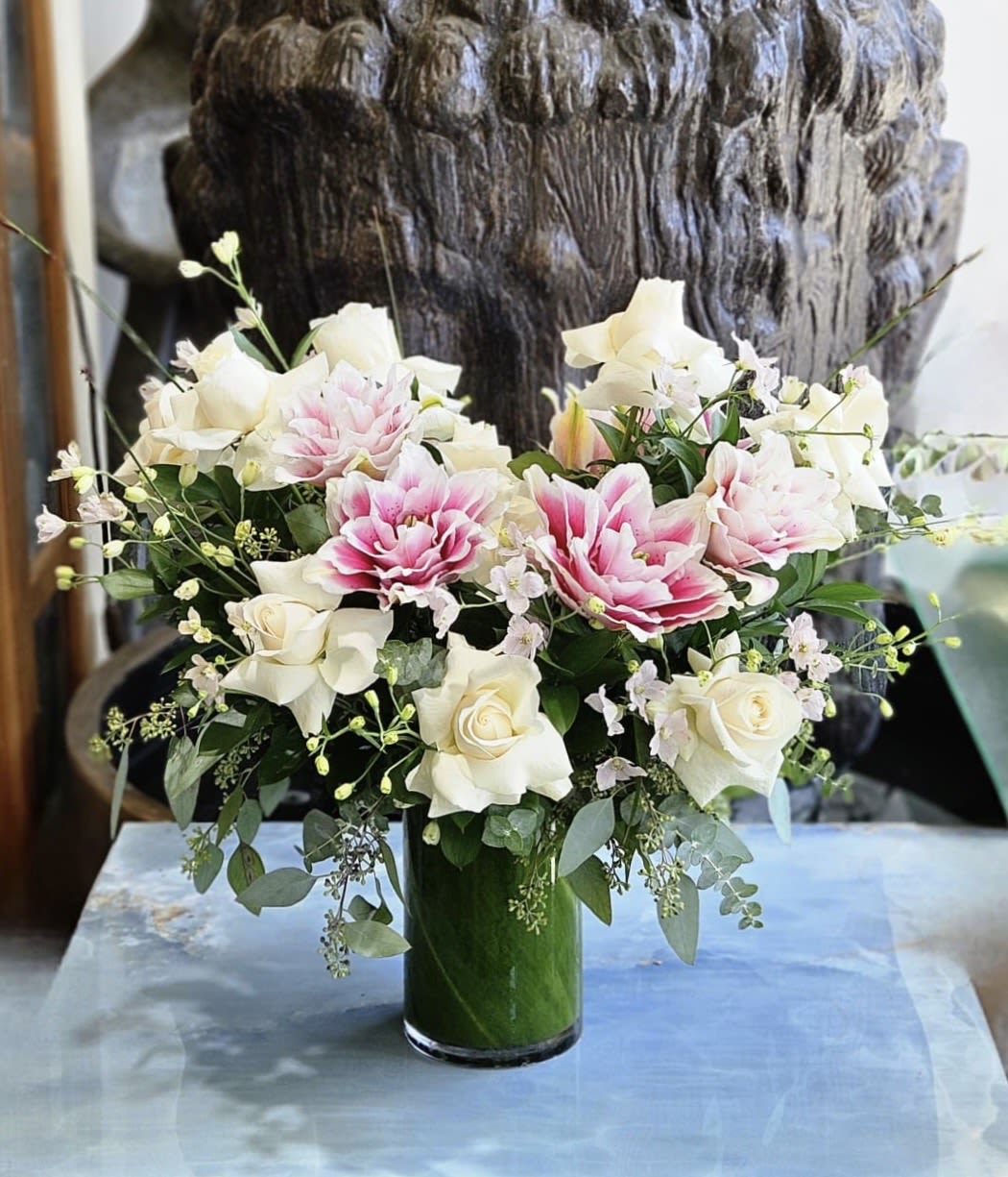Pink and white floral arrangement in a glass vase