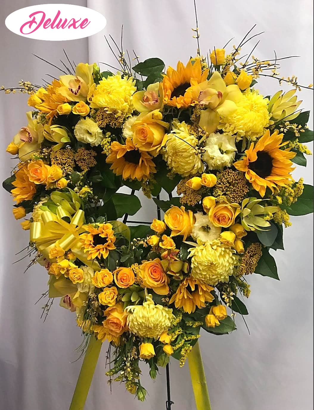 Heart-shaped yellow floral standing spray with sunflowers and roses