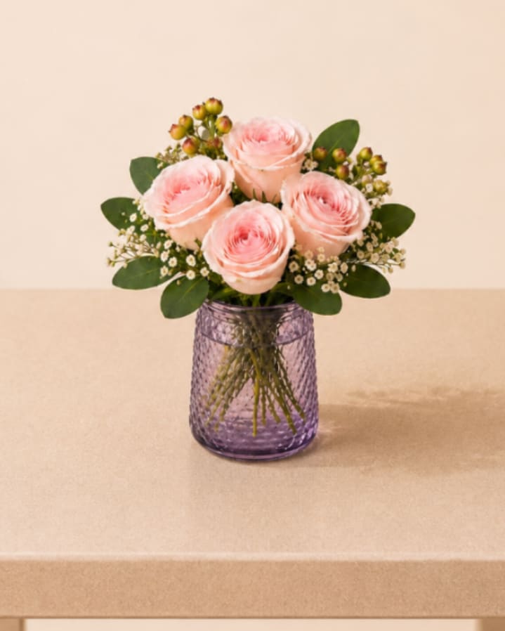 Signature Rose Vase Designer’s Choice Arrangement - A charming and elegant arrangement featuring four premium roses, beautifully accented with delicate baby’s breath and fresh greenery for a soft, natural touch. Designed in a modern textured vase that allows the stems to be visible, creating a fresh and contemporary presentation perfect for everyday gifting.   Better For: Spring, Mother’s Day, Women’s Day, Birthdays, Thank You, Love, Thinking of You, Friendship, Yellow Flower’s Day.   Flower varieties, vase style, and color tones will be selected by our florist and may vary depending on seasonal availability. Our designers will carefully create a beautiful arrangement inspired by the same overall style and spring color palette.
