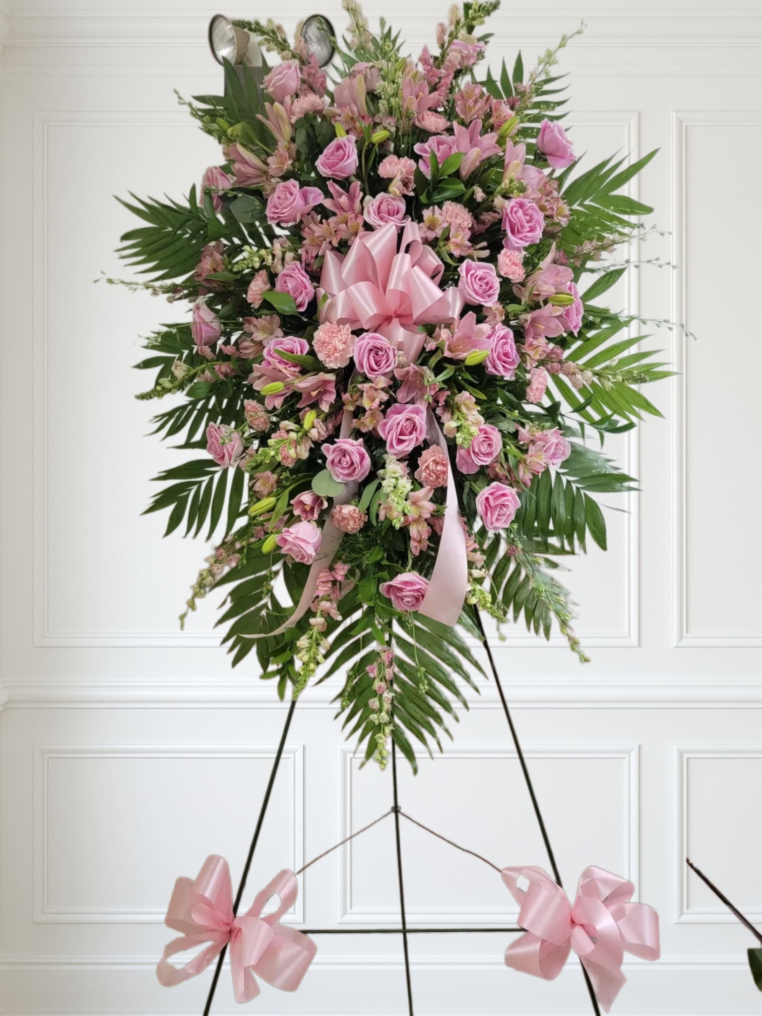 Compassion Spray by Manny - Pink roses, lilies, and more come together for a blushing pink standing funeral spray. 