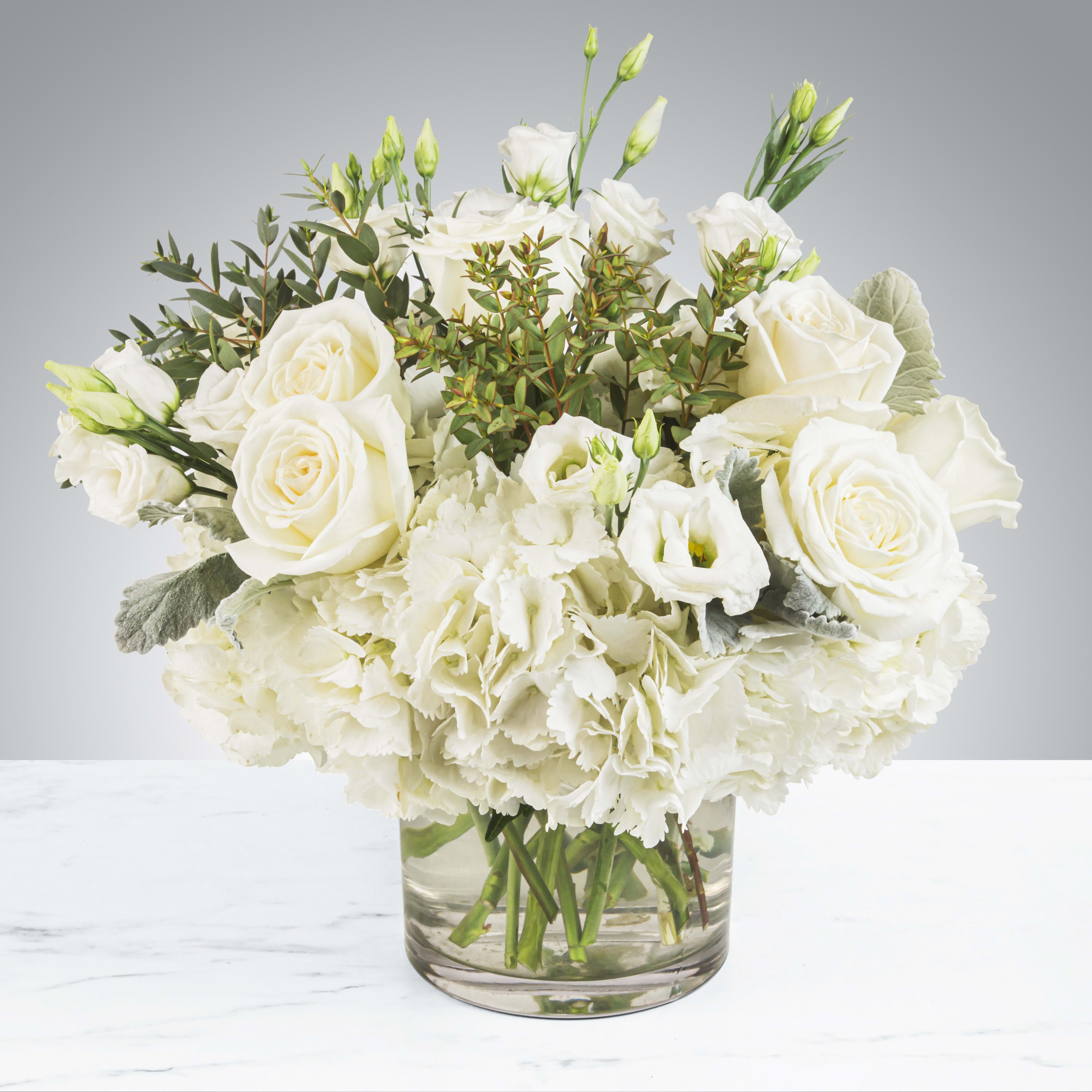 Designers Choice All White  - This all white arrangement includes roses, lisianthus and hydrangeas and the most beautiful white flowers in shop with winter greens. 