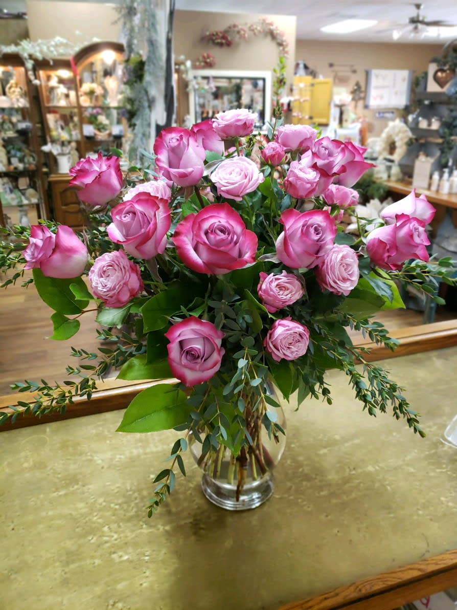 Pink roses arranged in a clear glass vase