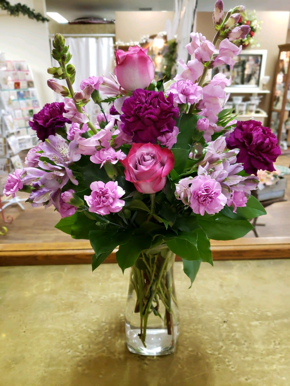 Pink and purple mixed bouquet in a clear glass vase