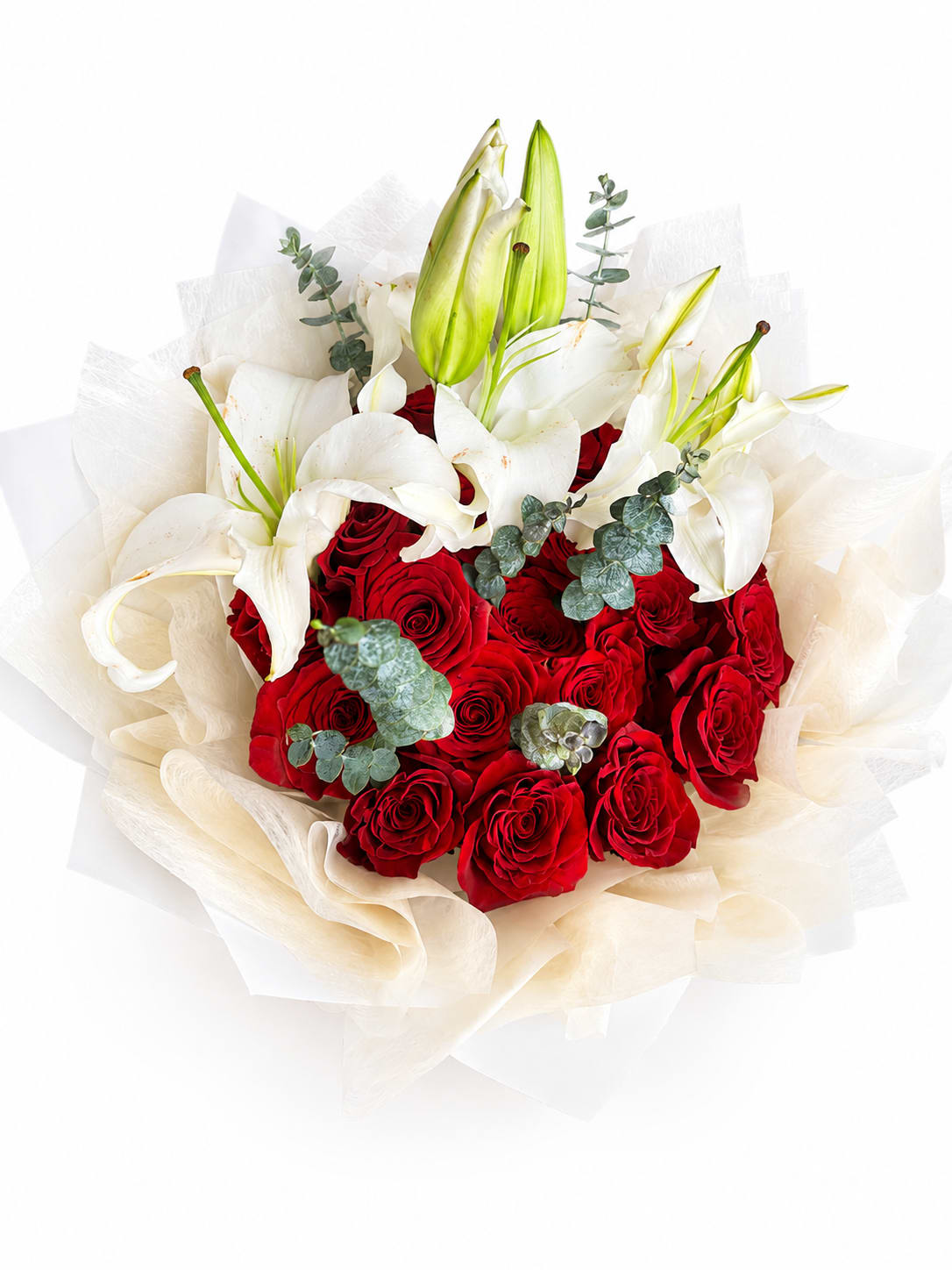 Bouquet of red roses and white lilies wrapped in cream paper