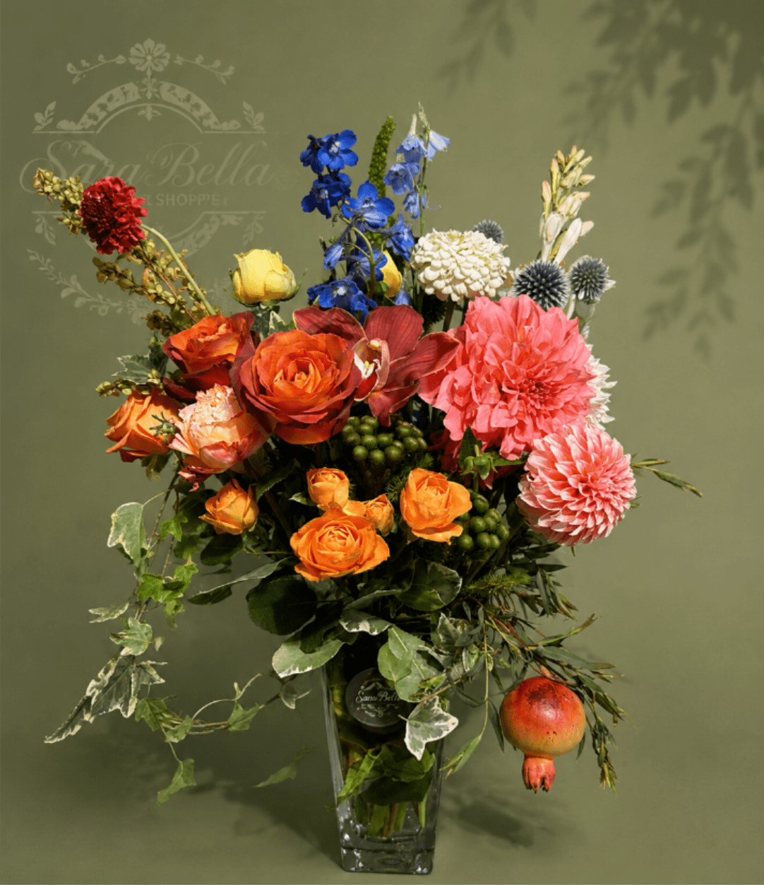 Sunset Orchard - An elegant arrangement of warm garden roses, vibrant dahlias, seasonal blooms, and lush greenery, finished with orchard-inspired textures for a naturally sophisticated look.
