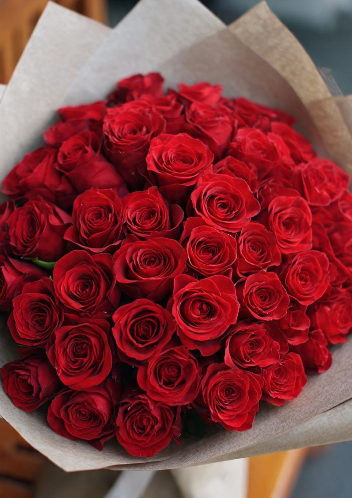 Large bouquet of red roses wrapped in paper