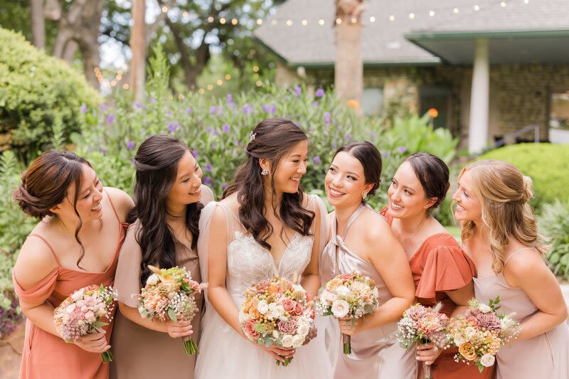 The Signature Bridesmaid Bouquet Collection - The Signature Bridesmaid Bouquet Collection  Select the perfect size to complement your wedding party's style. Choose from our three beautifully curated tiers, each custom-designed to match your chosen wedding color palette.  Choose Your Size: The Petite Posy  Charming, minimalist, and perfectly sweet. The Posy is a delicately gathered arrangement designed for a clean, understated look. It features a curated selection of focal blooms and light accent greenery. Best for an intimate, modern aesthetic or junior bridesmaids.  The Classic  Our signature size—timeless, full, and beautifully balanced. The Classic bouquet features a lush, generous mix of premium focal flowers, texture accents, and dimensional greenery. Best for the traditional wedding look and ideal camera-ready scale.  The Grande Premium  Luxurious, statement-making, and rich in texture. The Grande elevates your wedding party with maximum fullness and an abundance of high-end, premium focal stems for an organic, high-impact spread. Best for black-tie or luxury celebrations.  Note: Please adjust the quantity at checkout to match the total number of bridesmaids in your wedding party.