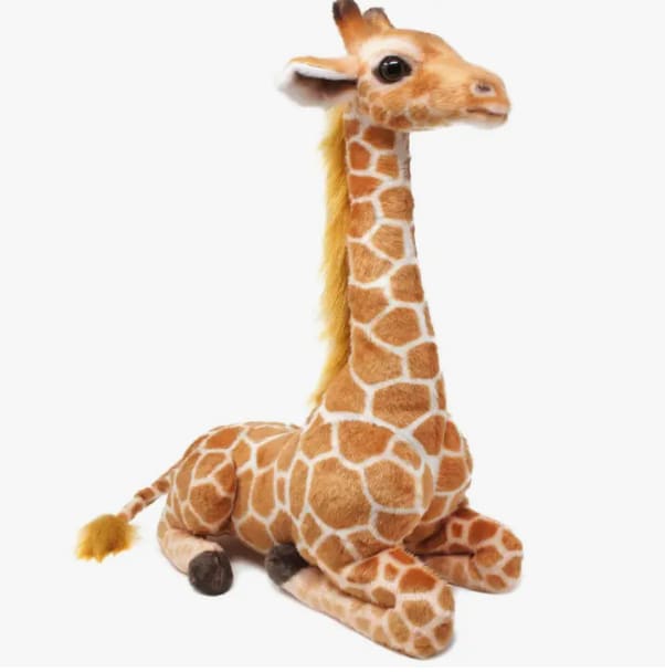 Plush giraffe toy sitting on a white background