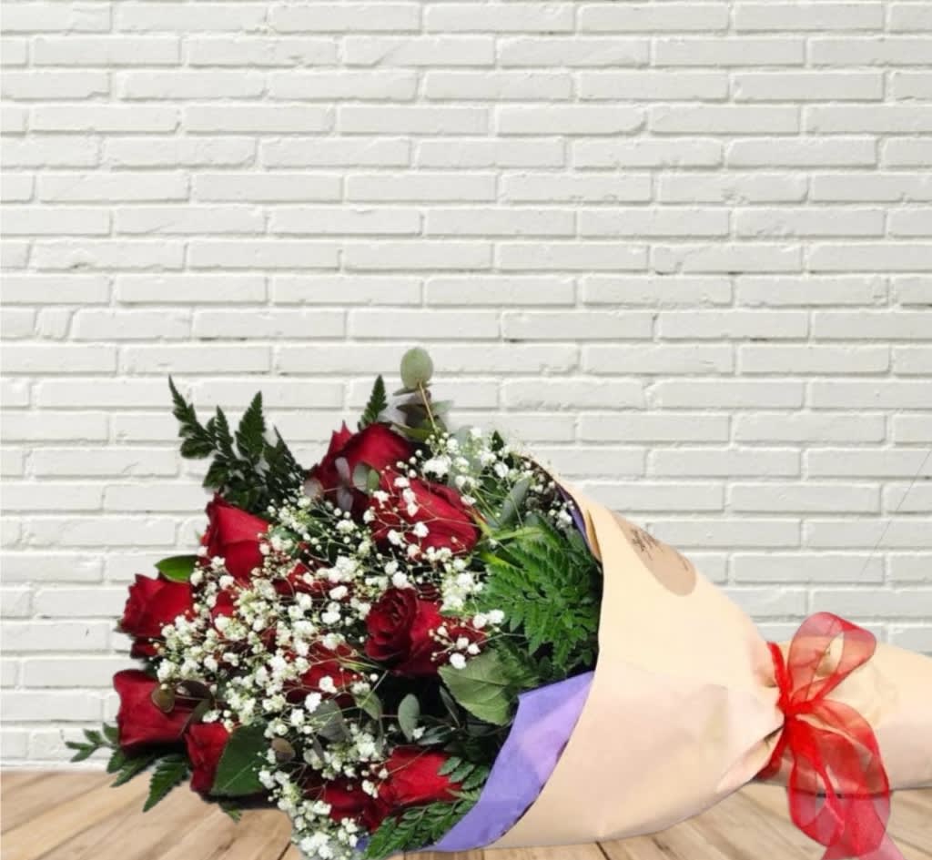 Bouquet of red roses with baby's breath wrapped in beige paper