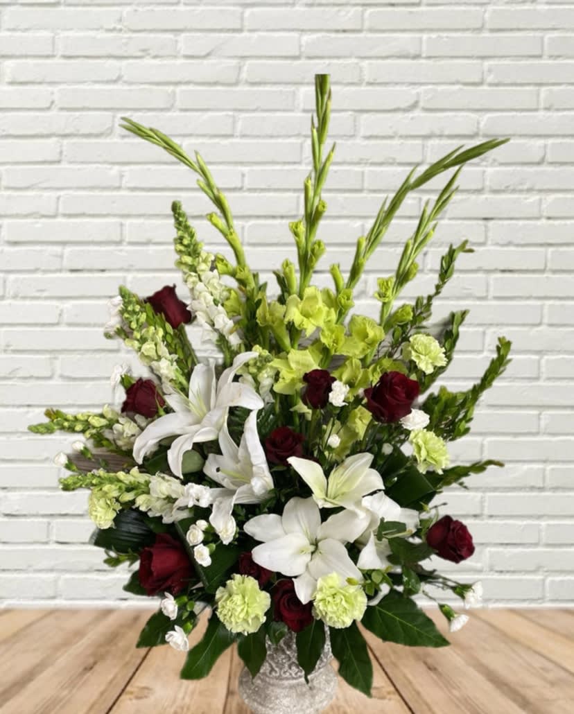 White lilies and burgundy roses in a decorative vase