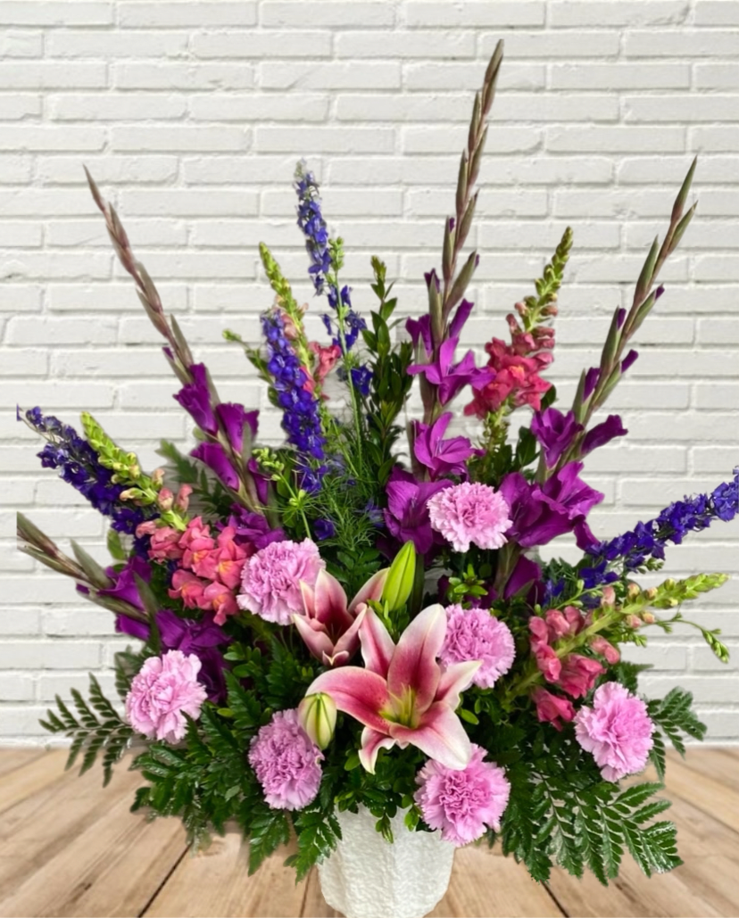 Treasured Memories - Purples &amp; Pinks in this one sided funeral arrangement.