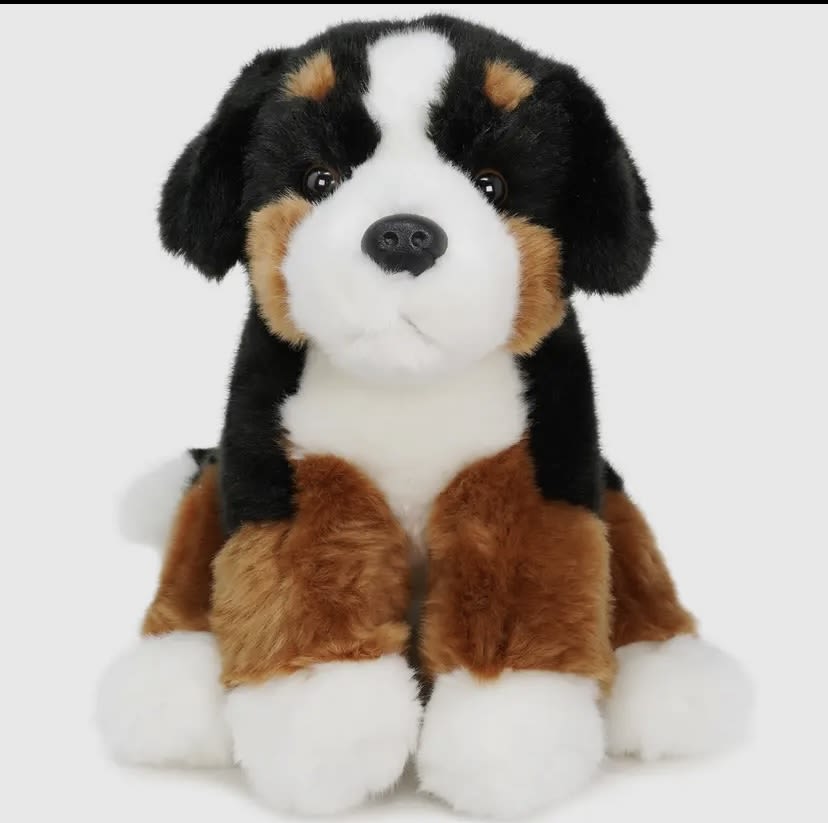 Plush stuffed dog toy with black, white, and brown fur
