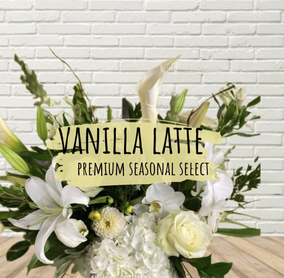 White floral arrangement with lilies, roses, and orchids