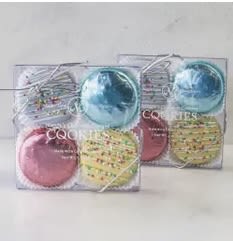 Two clear gift boxes of assorted frosted cookies in pastel colors tied with silver string