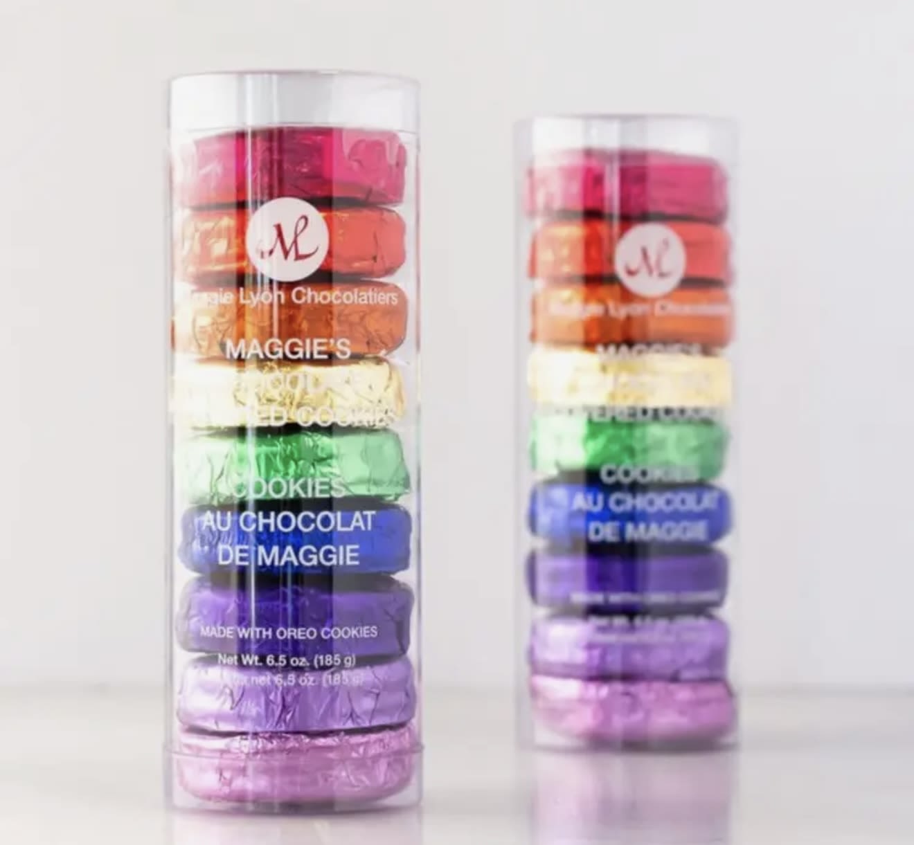 Two clear tubes of colorful stacked chocolates