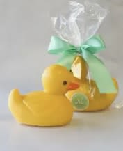 Yellow duck-shaped gift item wrapped in clear cellophane with a mint ribbon