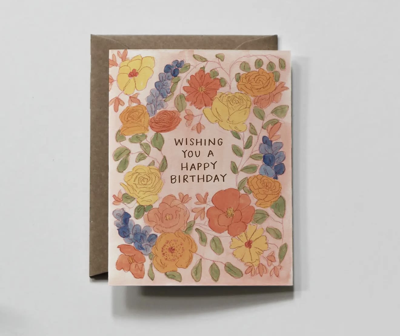 Birthday card with watercolor flowers and a brown envelope