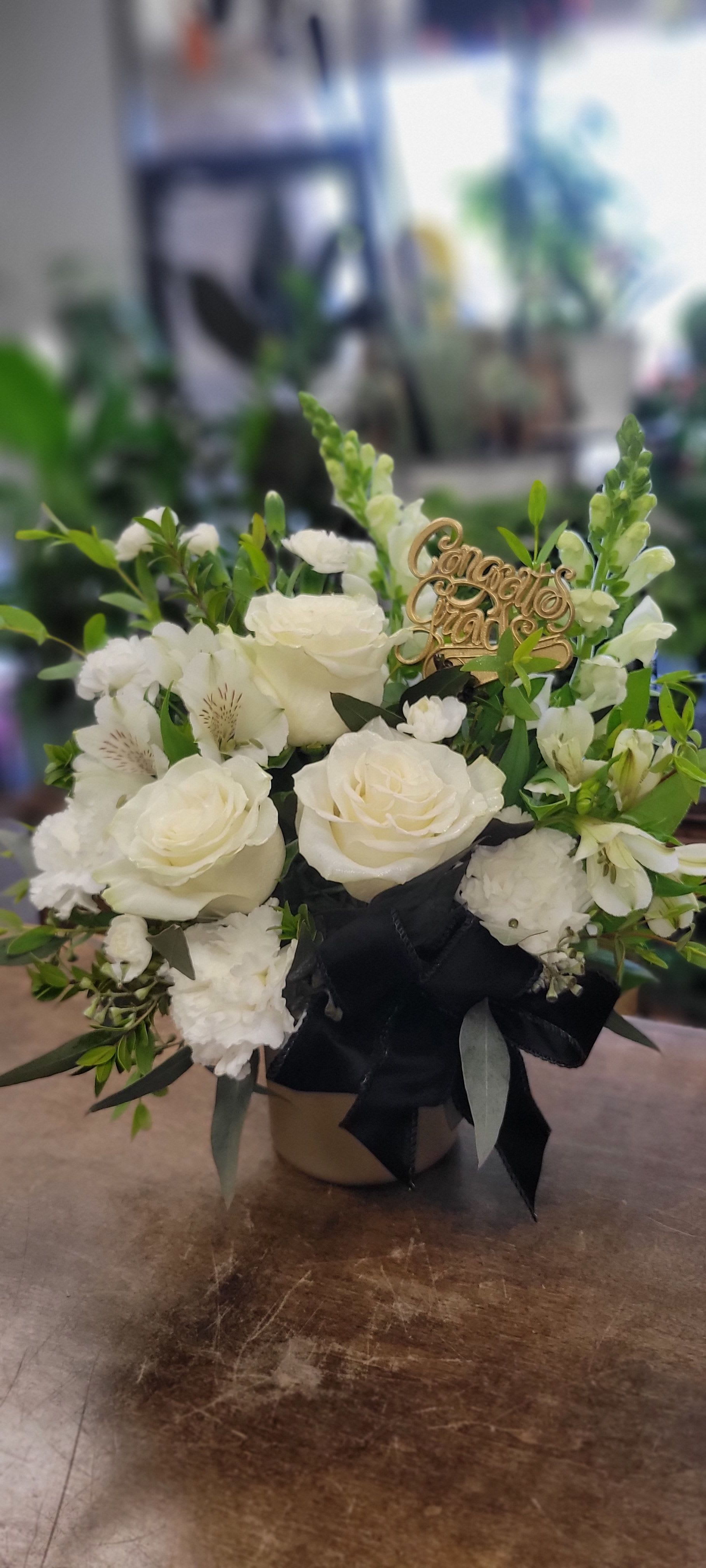 Congrats Grad Bouquet - Elegant white and black graduation arrangement with gold accents and a shimmering “Congrats Grad” pick for a chic, celebratory touch. 