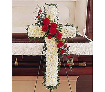 Floral cross on an easel with white and red flowers