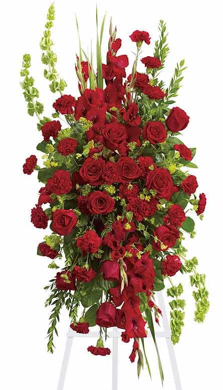 Tall red rose and carnation standing spray with green accents