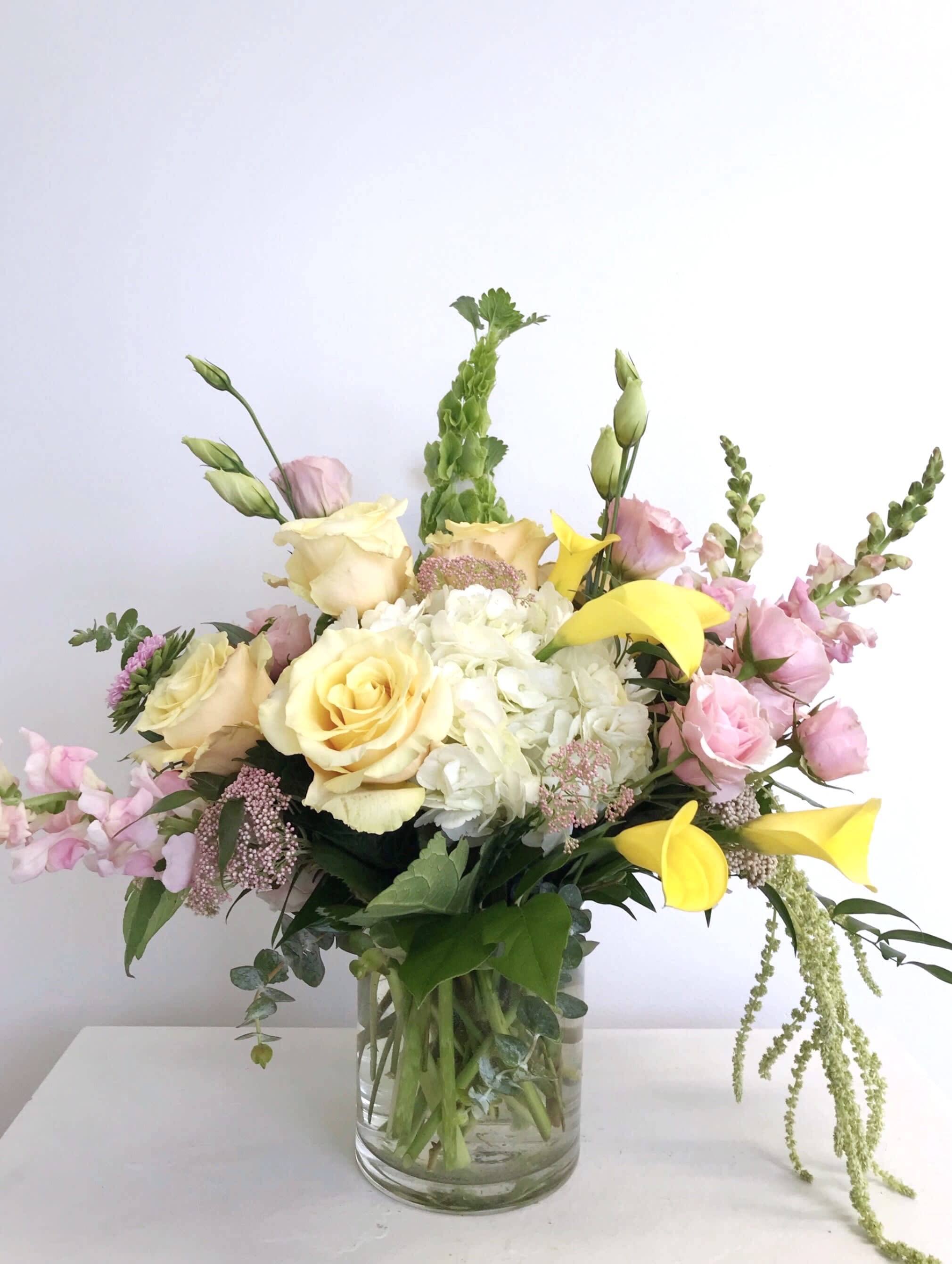 Bouquet of yellow and pink flowers in a glass vase