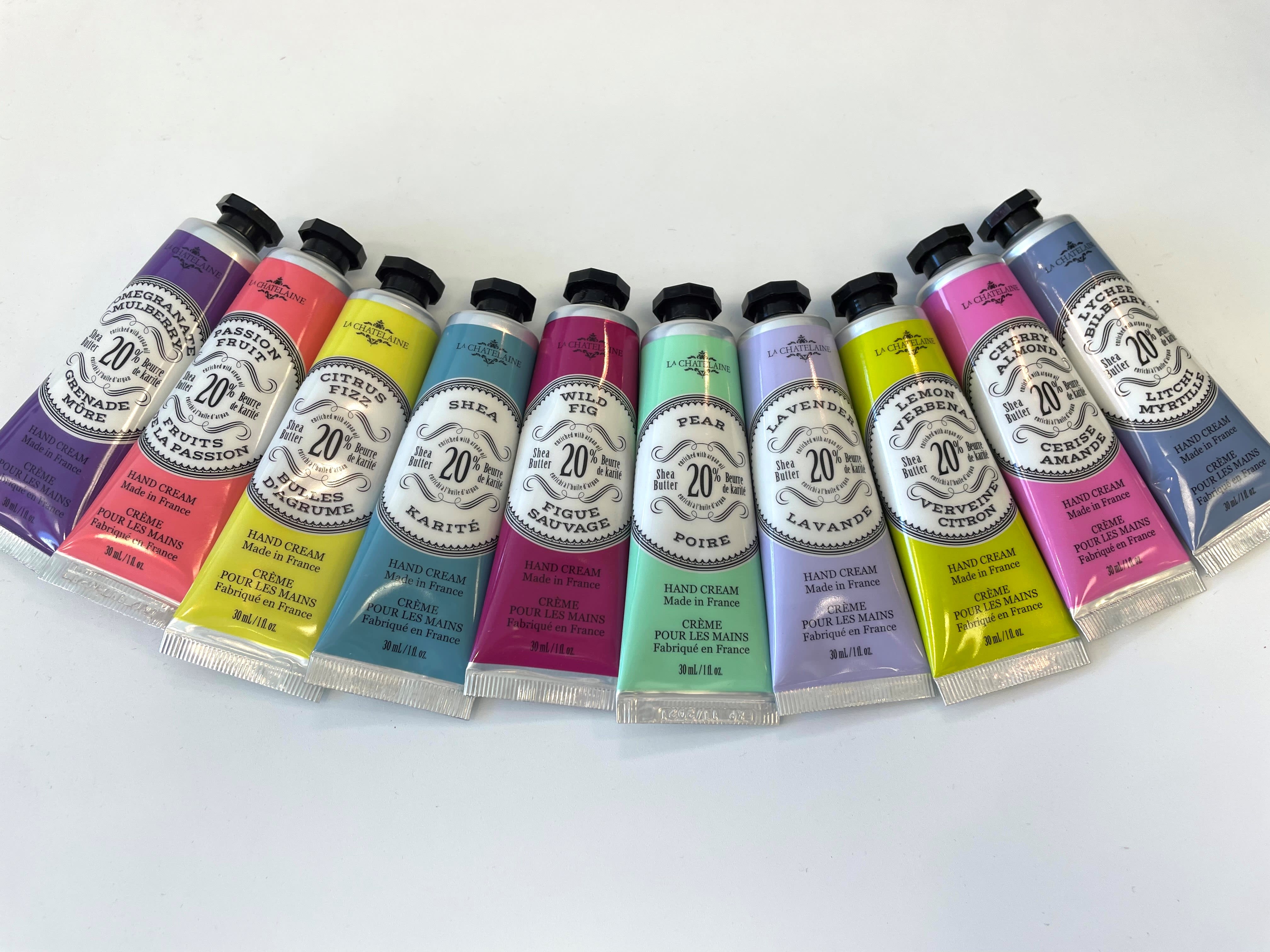 A row of colorful hand cream tubes arranged on a white surface