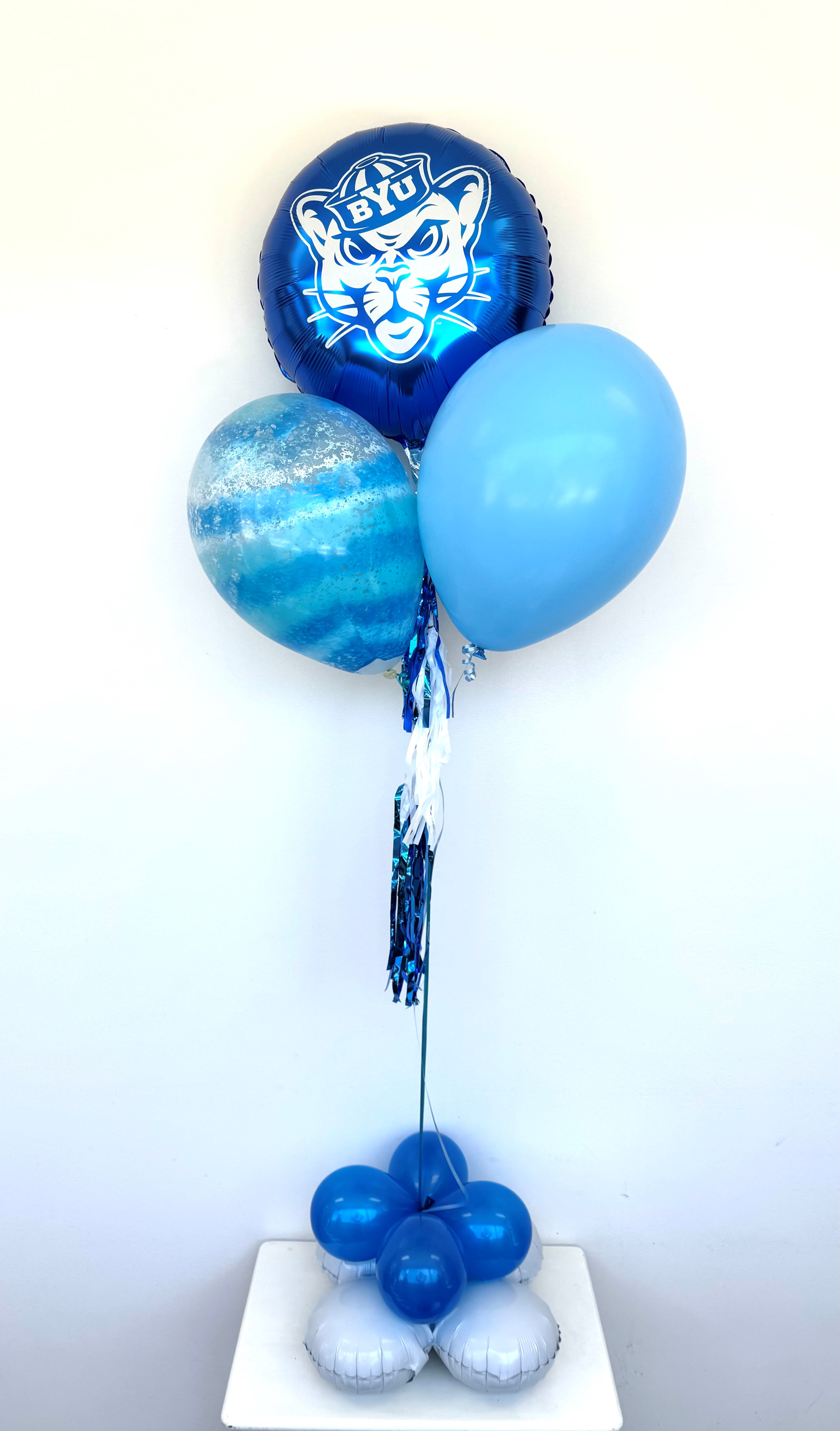 Blue balloon bouquet with a BYU mascot balloon on a weighted base