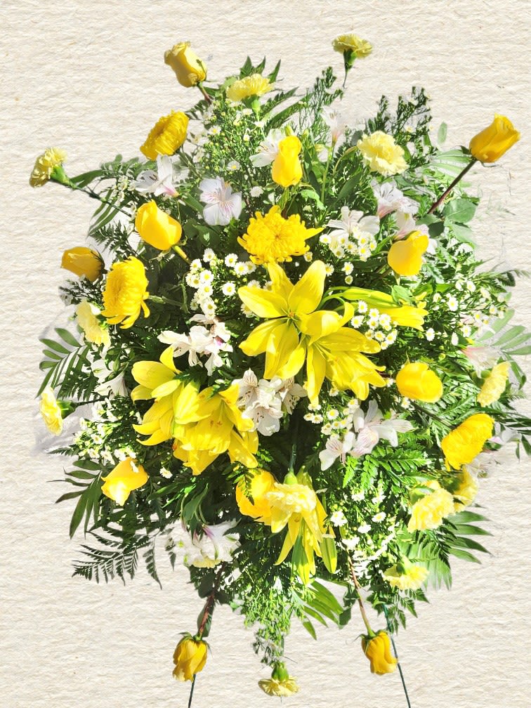 Yellow floral spray with lilies and mixed blooms