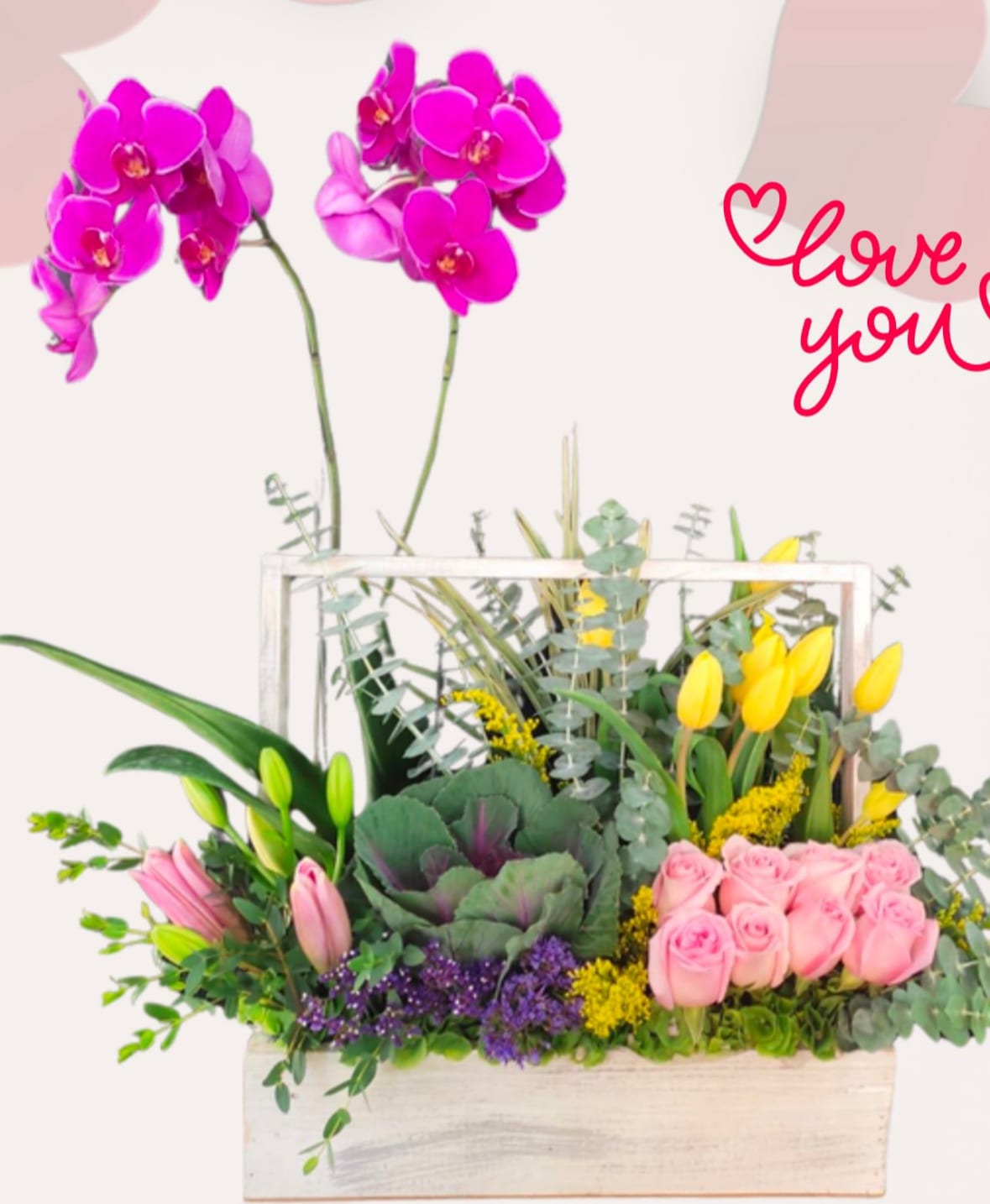 Mixed floral arrangement in a white wooden box with pink orchids and roses