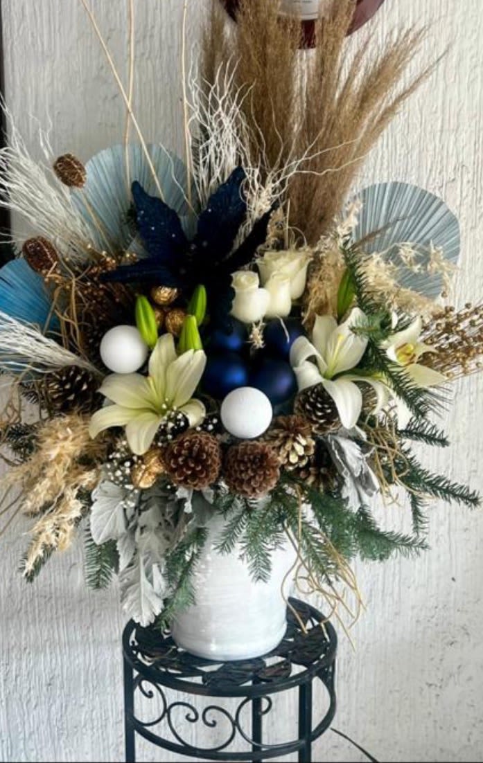 Winter Noel - Soft white and blue flowers mixed with winter greens, pinecones and natural textures.Calm, cozy and stylish