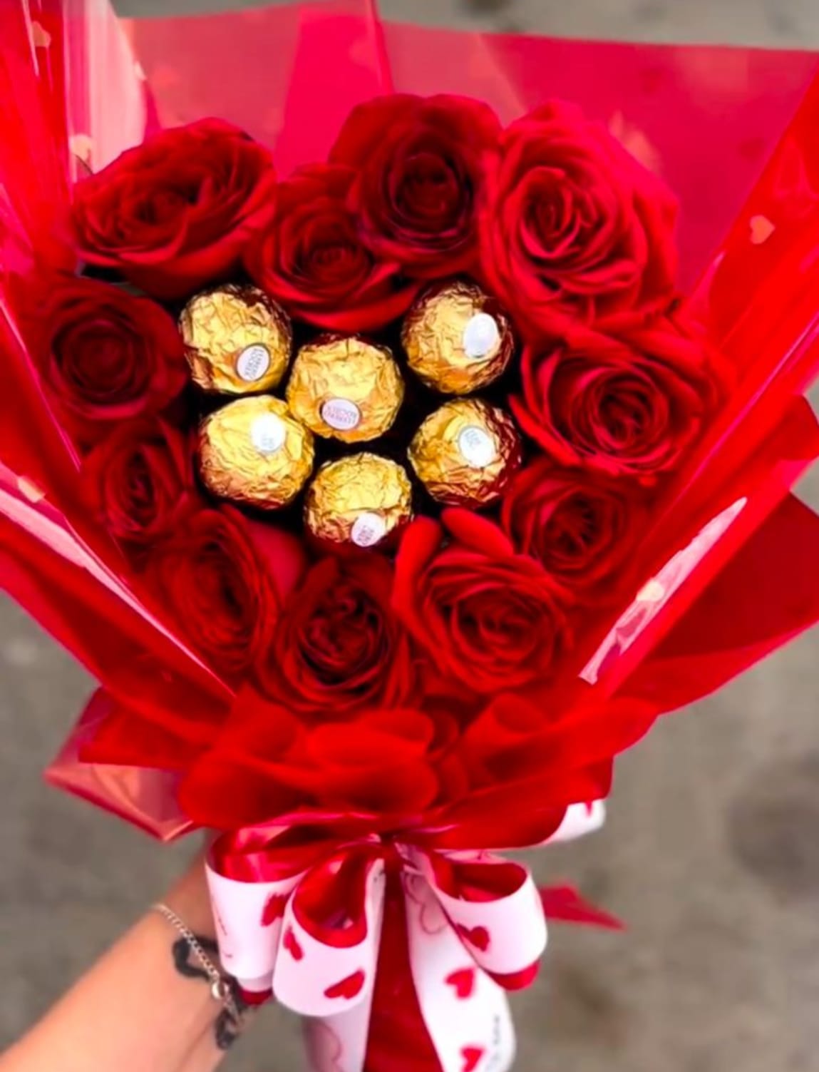 Emilia  - Romantic flower arrangement created with fresh 12 red roses and premium Ferrero Rocher chocolates, professionally designed as a luxury flower gift for Valentine´s Day and anniversary celebrations, styled in an elegant romantic look and handcrafted with care.
