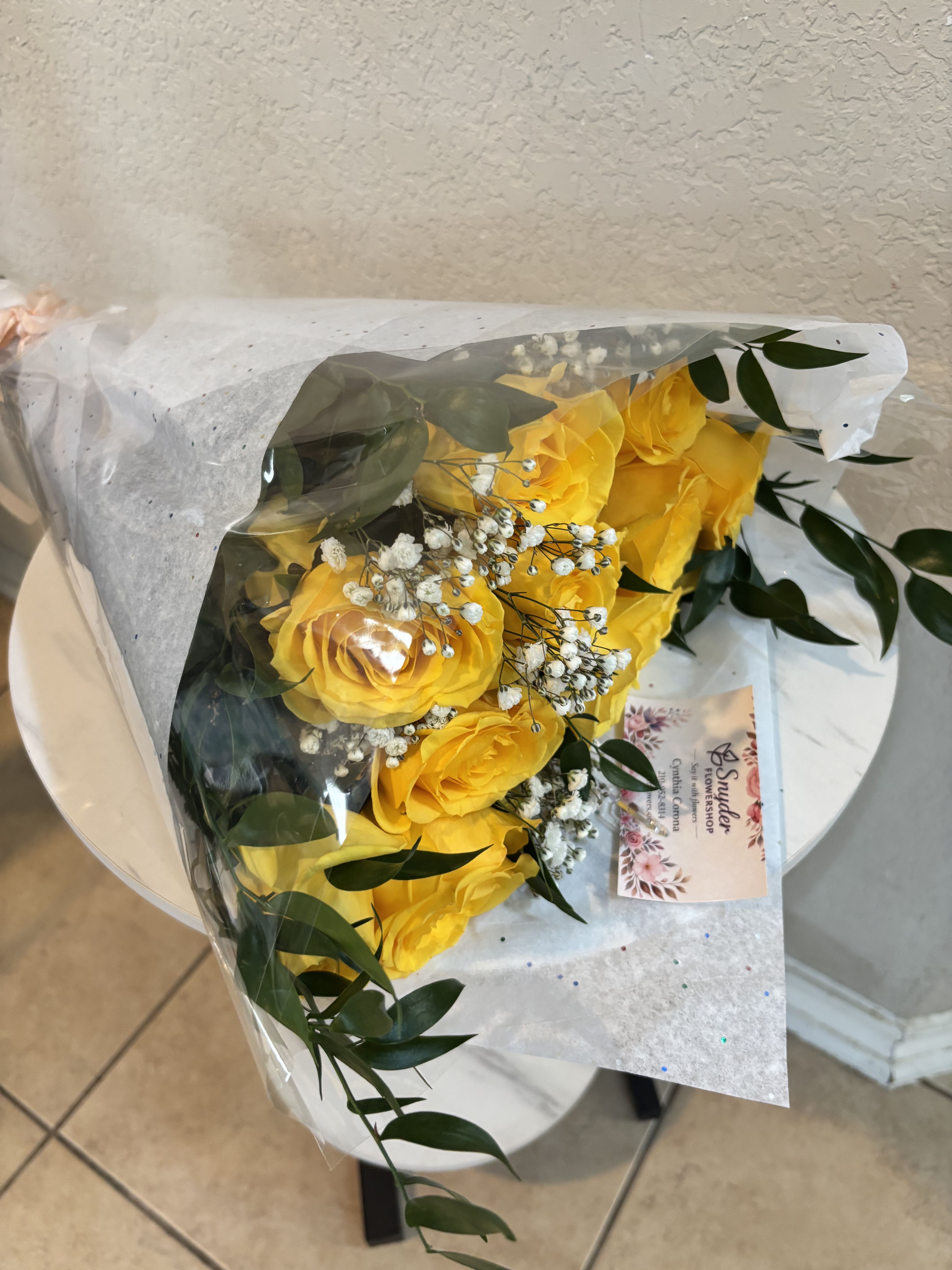 Yellow Rose Bouquet | Same-Day Flower Delivery San Antonio - Beautiful yellow rose bouquet in San Antonio featuring fresh premium yellow roses accented with baby’s breath and elegant greenery, wrapped in modern luxury floral paper for a timeless presentation. Handcrafted by Snyder Flowers San Antonio, this cheerful bouquet symbolizes friendship, happiness, appreciation, and positive energy, making it perfect for birthdays, congratulations, thank you gifts, get well wishes, or special surprises.   We proudly offer same-day flower delivery in San Antonio including Stone Oak, Medical Center, Alamo Heights, Cibolo, Helotes, and surrounding areas.  Elegant floral gifts created with fresh high-quality roses and beautiful handcrafted wrapping.  Looking for a trusted florist in San Antonio, yellow roses near you, or same day bouquet delivery? Snyder Flowers creates fresh luxury rose bouquets designed to brighten every special moment.