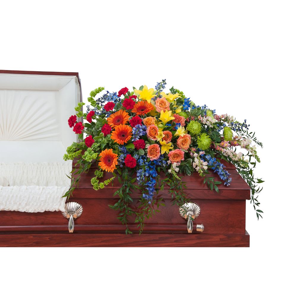 Colorful flower spray on a wooden casket