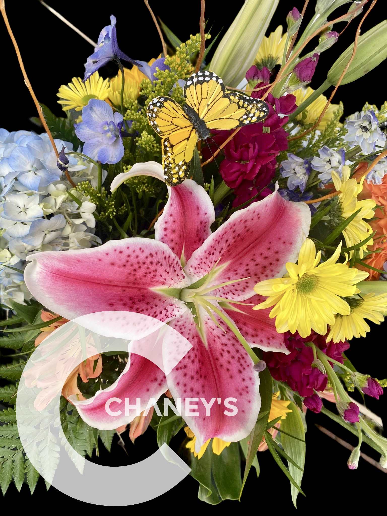 Colorful bouquet with a large pink lily and a butterfly accent