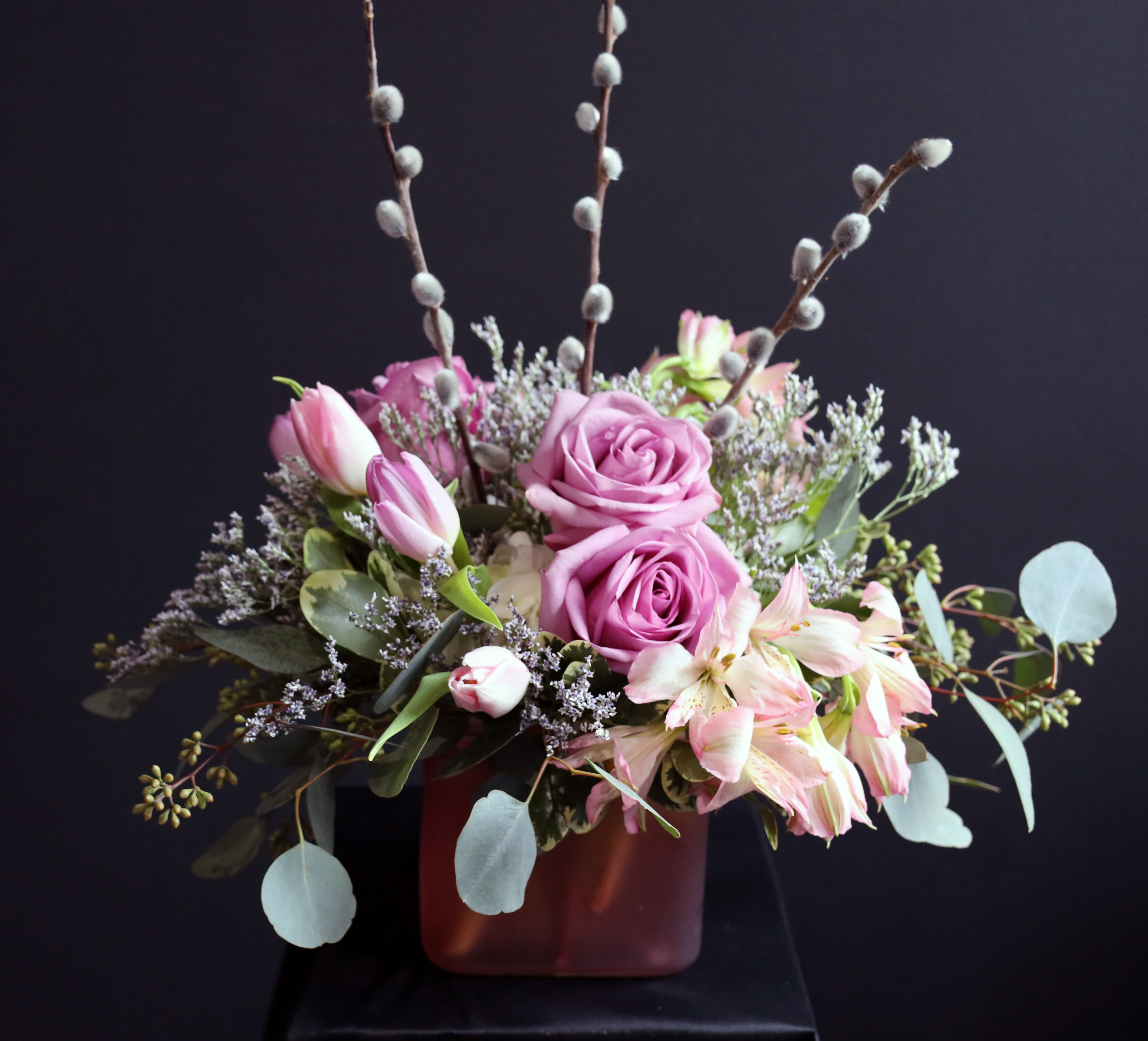 Chanel - A eye catching fashion piece with free flowing design and beauty made with roses, tulips, alstroemeria, pussy willow, and more! 