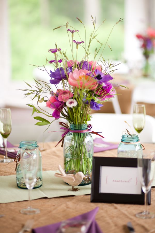 Colorful bouquet in a glass jar centerpiece on a table