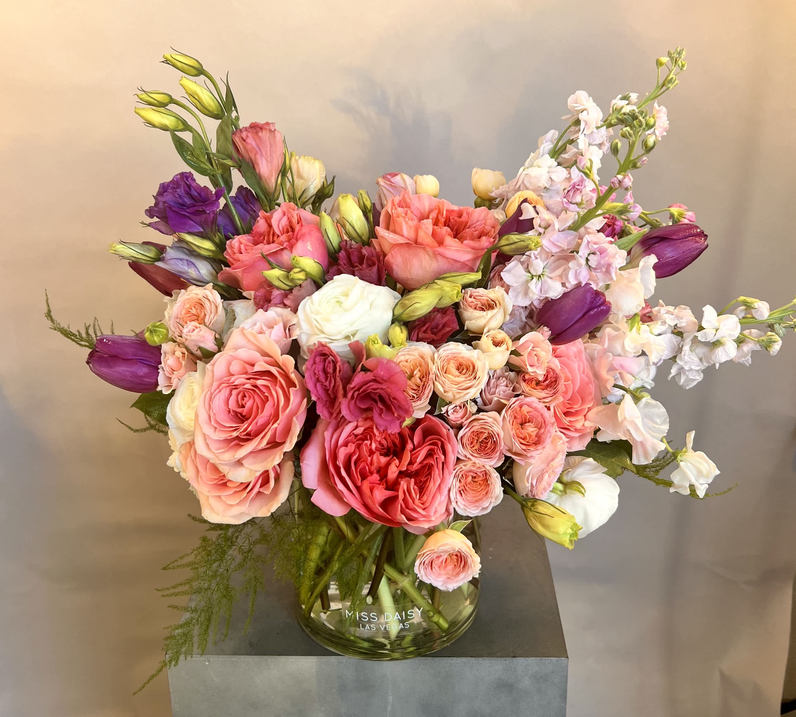 Mixed pink and purple bouquet in a glass vase