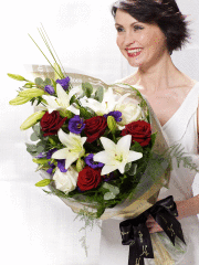Bouquet of red roses and white lilies with purple accents