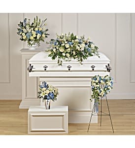 White casket with blue and white floral sprays
