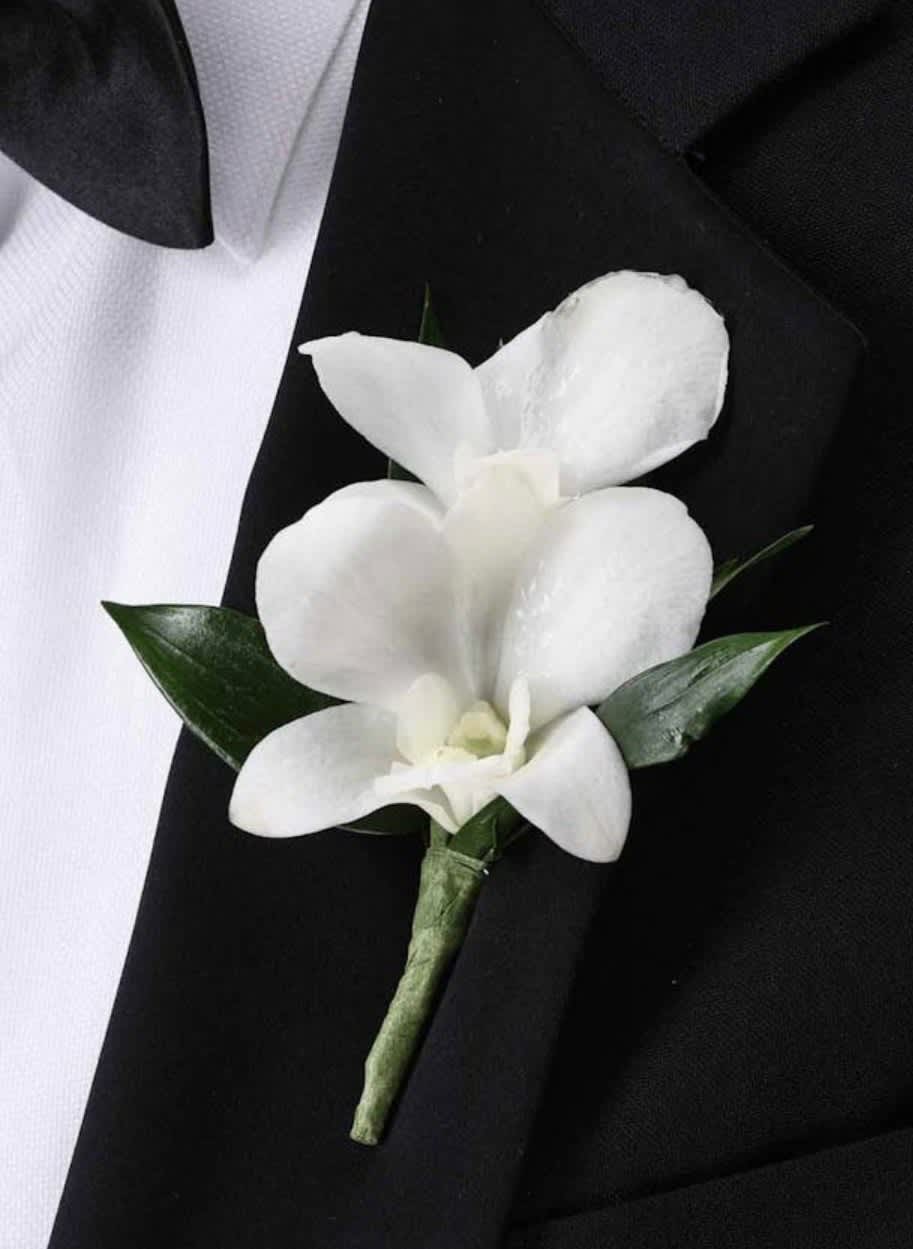 White orchid boutonniere on a black suit jacket