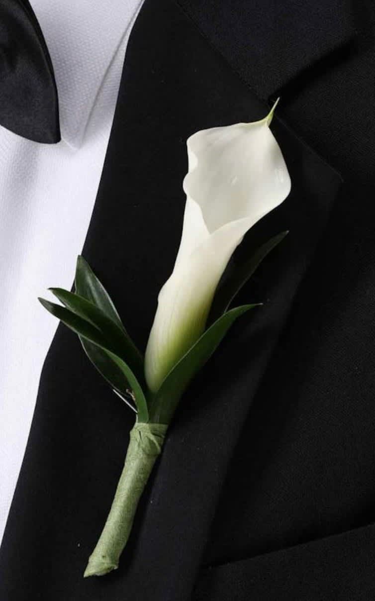 White calla lily boutonniere on a black suit jacket
