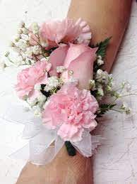 Pink corsage with white baby's breath on a wrist