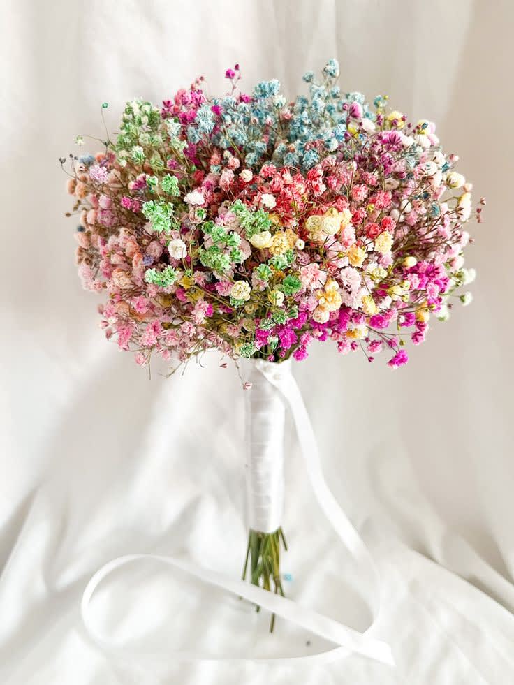 Colorful bouquet of tiny clustered flowers tied with a white ribbon