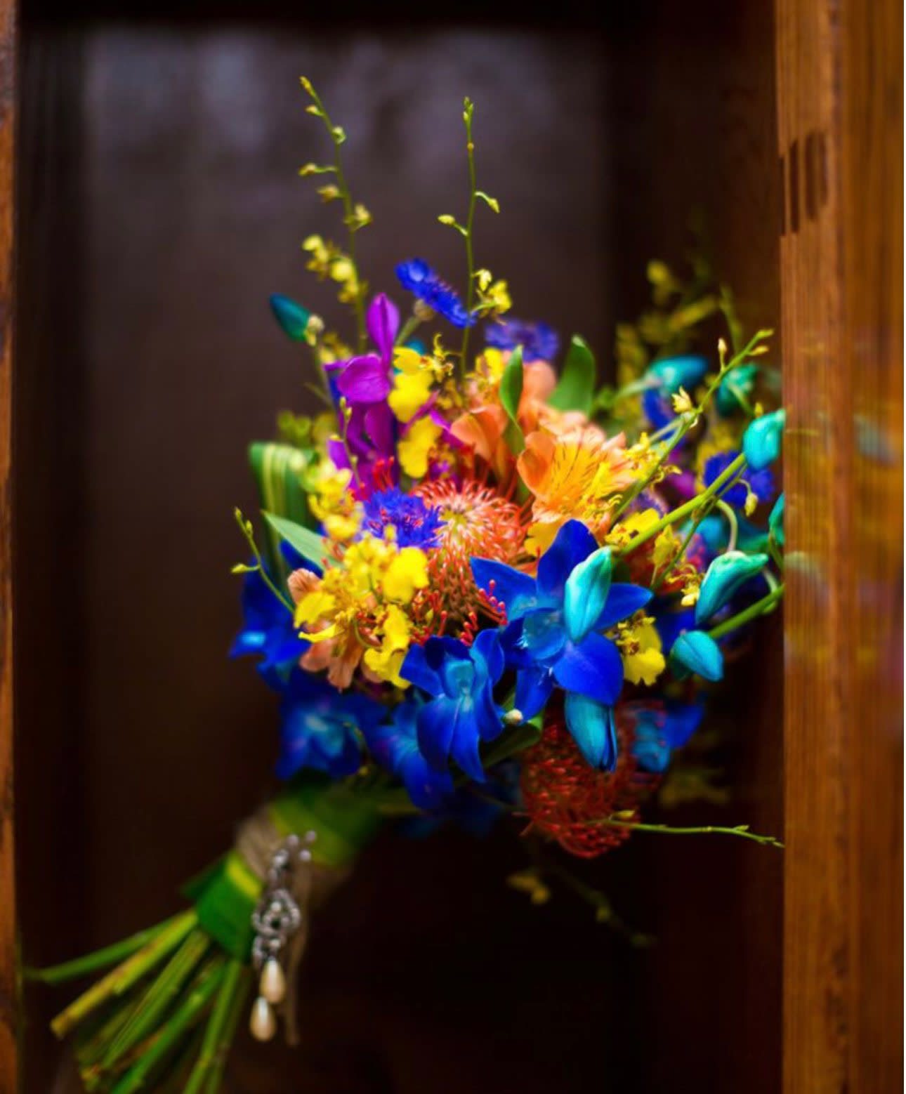 Bright multicolored bouquet with blue, purple, yellow, and peach flowers